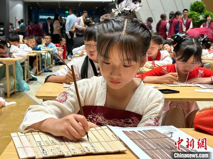 圖為小朋友在甘肅簡牘博物館練習(xí)書法?！≈行律缬浾?戴文昌 攝
